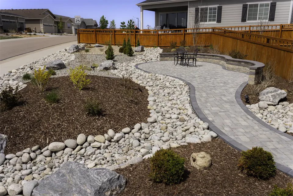 Paver walk through river-rock beds